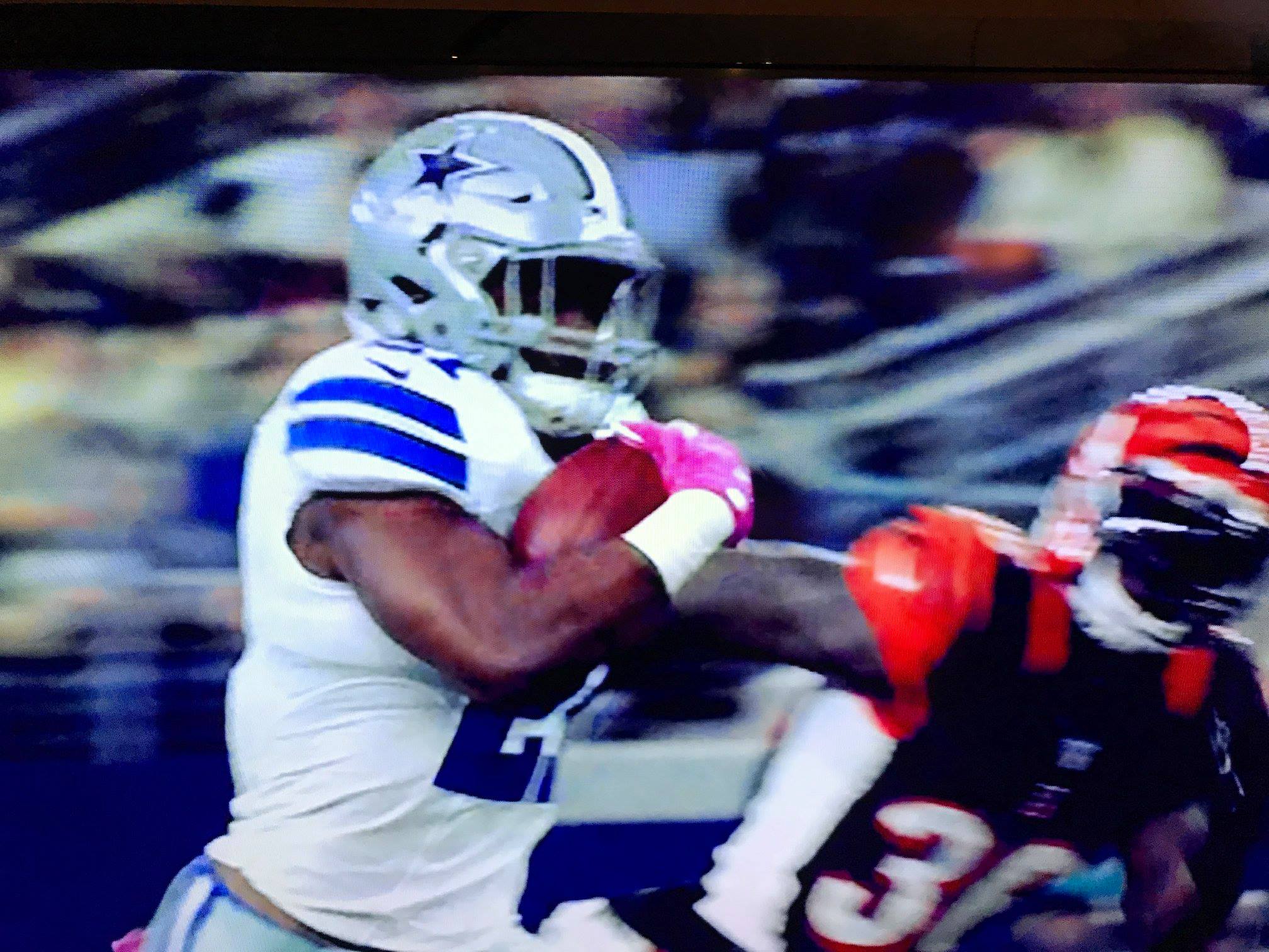 Photograph of Dallas Cowboys player running with football