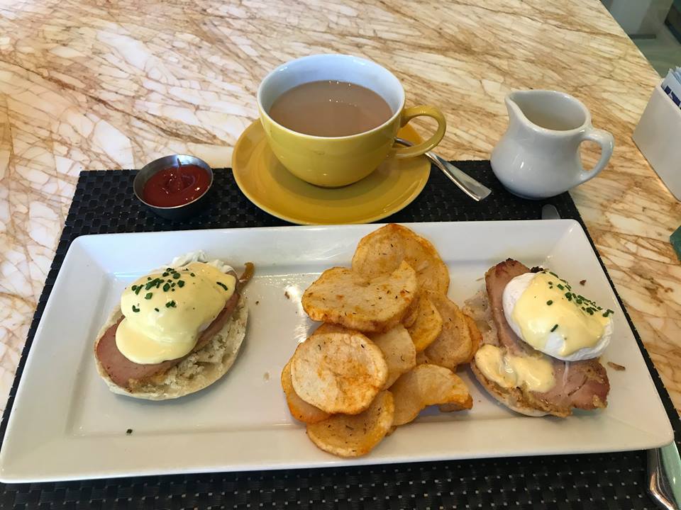 Picture of breakfast (eggs Benedict, hash browns, coffee, ketchup)